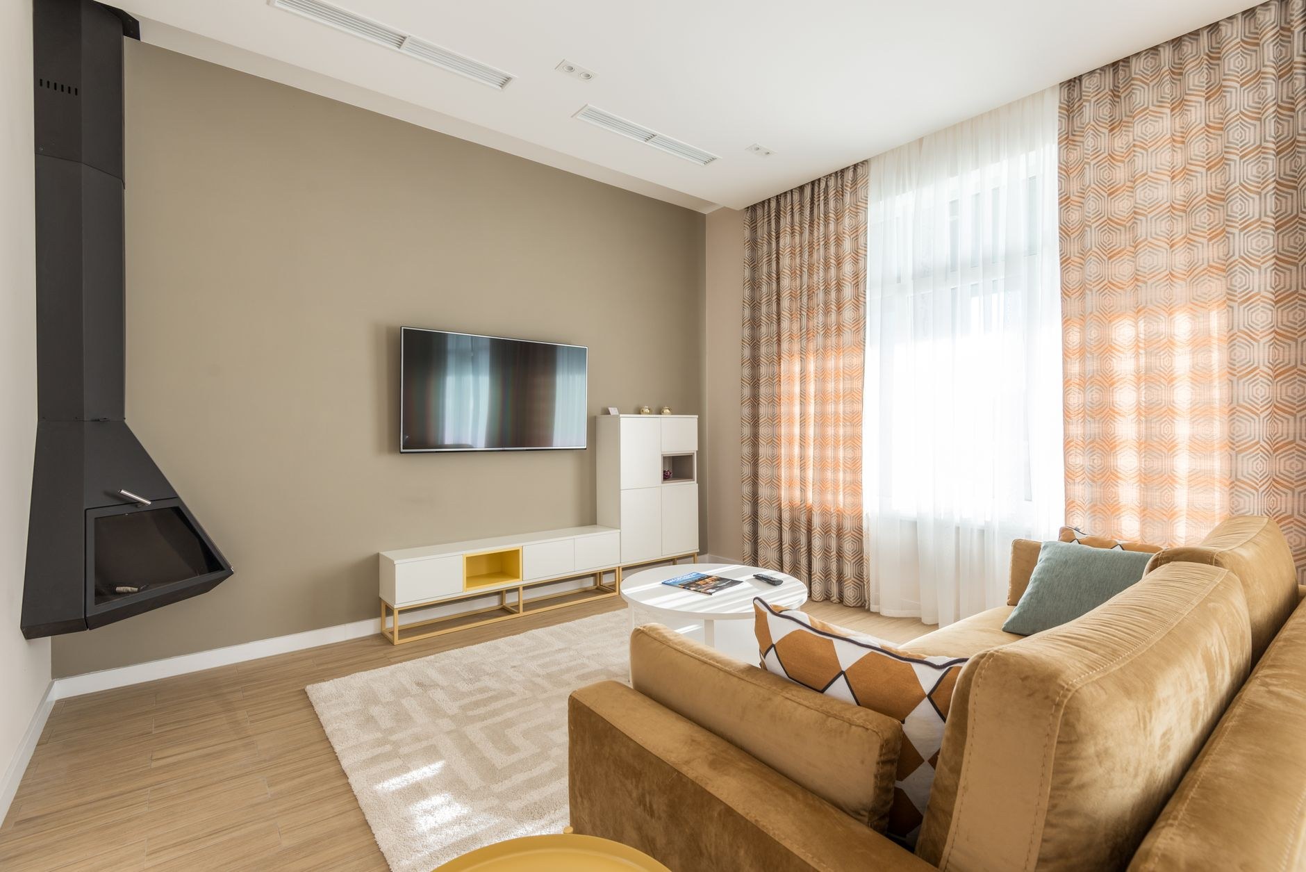 White wall-mounted heat pump warming a modern living room